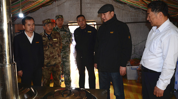 在阿龍山林業局駐汗馬保護區靠前駐防站，閆宏光查看撲火隊員工作生活條件，了解駐防隊伍液化氣和木柴兩用爐灶使用情況.JPG